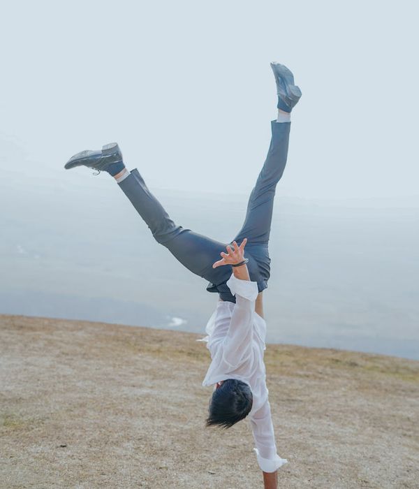 Man performing a controlled bodyweight exercise on a mat.